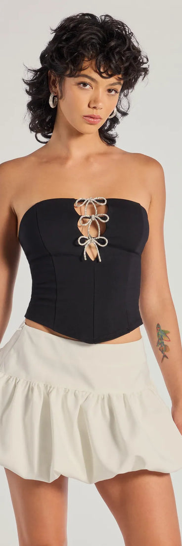 The Adorable Glam Rhinestone Bow Cutout Corset Top in black with a modern design and trendy look is part of the latest women's tops collection to elevate your 2025 wardrobe.