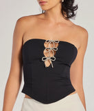 The waist-defining bodice style of the Adorable Glam Rhinestone Bow Cutout Corset Top in black is perfect for making a statement with your outfit and provides the structure, molded cups, or lace-up details that capture the corset trend.