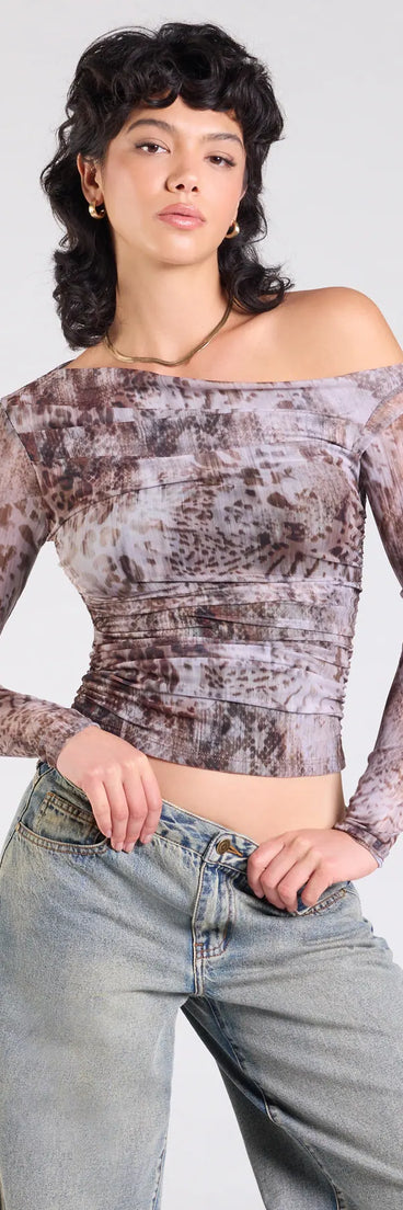 The Wildly Chic Long Sleeve Abstract Print Crop Top in multi-color brings edge and energy to your vibe, ready to elevate any festival look or concert outfit.