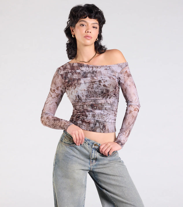 The Wildly Chic Long Sleeve Abstract Print Crop Top in multi-color brings edge and energy to your vibe, ready to elevate any festival look or concert outfit.