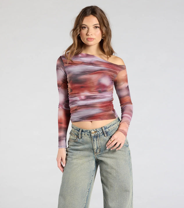 The Wildly Chic Long Sleeve Abstract Print Crop Top in multi-color brings edge and energy to your vibe, ready to elevate any festival look or concert outfit.