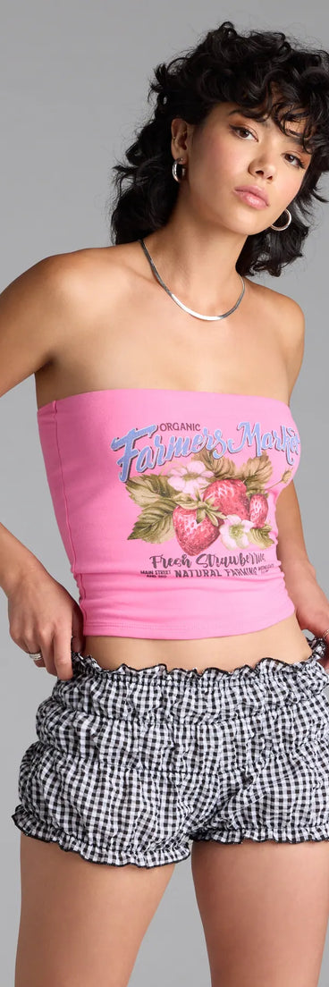 The Farmer's Market Graphic Tube Top in pink brings edge and energy to your vibe, ready to elevate any festival look or concert outfit.