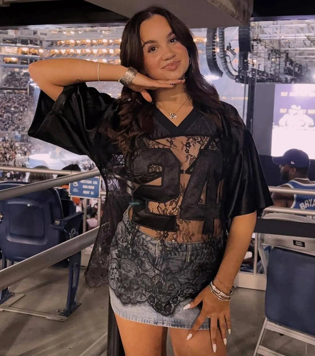 Perfect for layering or wearing solo, this short sleeve top features the Sporty Chic Lace V-Neck 24 Graphic Jersey Top in black for effortless everyday styling with jeans, cargos, or skirts.
