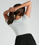 Elevate your winter outfits with the Smooth Silhouette Scoop Neck Short Sleeve Bodysuit, a white bodysuit designed for confident and effortless styling with anything from mini skirts to high-waist jeans.