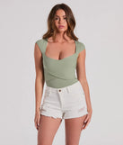 The Sweet Traits Cap Sleeve Crisscross Rib Knit Bodysuit in sage green with a modern design and trendy look is part of the latest women's tops collection to elevate your 2025 wardrobe.