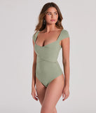 Elevate your winter outfits with the Sweet Traits Cap Sleeve Crisscross Rib Knit Bodysuit, a sage bodysuit designed for confident and effortless styling with anything from mini skirts to high-waist jeans.