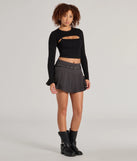 The Snuggle Worthy Ribbed Knit Long Sleeve Top is a cozy black sweater top crafted from textured knits, perfect for transitional weather outfits or adding a warm layer to a casual day look.