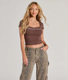 The Center Of The Universe Graphic Tee in brown with a modern design and trendy look is part of the latest women's tops collection to elevate your 2025 wardrobe.