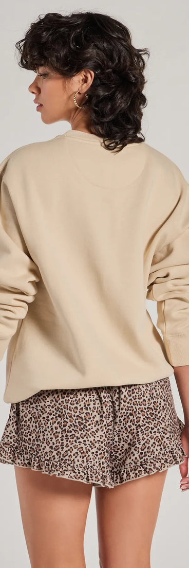 Layer-friendly Sporty Era Oversized Fleece Screen Sweatshirt is a chic, transitional tan long-sleeve top with contemporary sleeves and neckline design, ideal for an elevated cozy style or casual elegance.