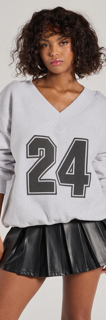 Layer-friendly 24 Graphic Oversized Pullover Sweatshirt is a chic, transitional gray long-sleeve top with contemporary sleeves and neckline design, ideal for an elevated cozy style or casual elegance.