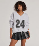 Layer-friendly 24 Graphic Oversized Pullover Sweatshirt is a chic, transitional gray long-sleeve top with contemporary sleeves and neckline design, ideal for an elevated cozy style or casual elegance.