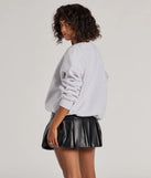 Layer-friendly 24 Graphic Oversized Pullover Sweatshirt is a chic, transitional gray long-sleeve top with contemporary sleeves and neckline design, ideal for an elevated cozy style or casual elegance.
