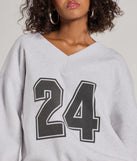 Layer-friendly 24 Graphic Oversized Pullover Sweatshirt is a chic, transitional gray long-sleeve top with contemporary sleeves and neckline design, ideal for a cozy holiday style or casual elegance.