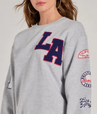 Layer-friendly LA Graphic Fleece Sweatshirt is a chic, transitional gray long-sleeve top with contemporary sleeves and neckline design, ideal for an elevated cozy style or casual elegance.