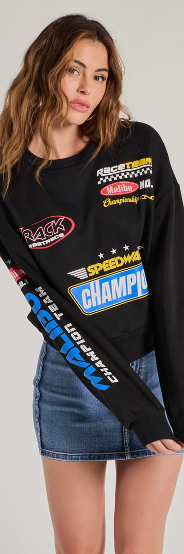 The Trendy Moto Graphic Fleece Pullover Sweatshirt in black with a modern design and trendy look is part of the latest women's tops collection to elevate your 2025 wardrobe.