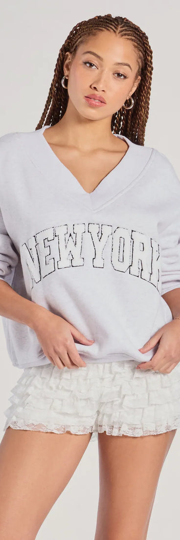 The New York V-Neck Fleece Oversized Sweatshirt in gray with a modern design and trendy look is part of the latest women's tops collection to elevate your 2025 wardrobe.