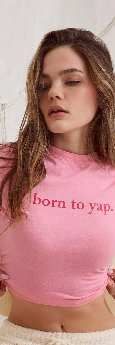 Stay on-trend this season with the Born To Yap Graphic Tee in pink, a must-have for creating stylish and effortless summer outfits for women.