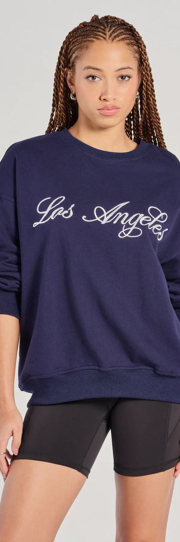 The Los Angeles Embroidered Oversized Sweatshirt in navy blue with a modern design and trendy look is part of the latest women's tops collection to elevate your 2025 wardrobe.