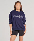 The Los Angeles Embroidered Oversized Sweatshirt in navy blue with a modern design and trendy look is part of the latest women's tops collection to elevate your 2025 wardrobe.