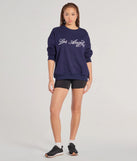 The Los Angeles Embroidered Oversized Sweatshirt in navy blue with a modern design and trendy look is part of the latest women's tops collection to elevate your 2025 wardrobe.