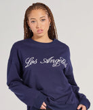 The Los Angeles Embroidered Oversized Sweatshirt in navy blue with a modern design and trendy look is part of the latest women's tops collection to elevate your 2025 wardrobe.