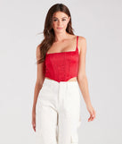 The waist-defining bodice style of the Heat Of The Moment Rhinestone Satin Corset Top in red is perfect for making a statement with your outfit and provides the structure, molded cups, or lace-up details that capture the corset trend.