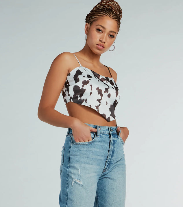 Country Chick Cow Print Satin Crop Top, a trendy white addition to women's going-out outfits, is ideal for Christmas party outfits, chic NYE attire, or winter night-out looks that keep you on-trend!