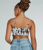 Country Chick Cow Print Satin Crop Top, a trendy white addition to women's going-out outfits, is ideal for Christmas party outfits, chic NYE attire, or winter night-out looks that keep you on-trend!