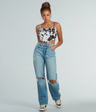 Country Chick Cow Print Satin Crop Top, a trendy white addition to women's going-out outfits, is ideal for Christmas party outfits, chic NYE attire, or winter night-out looks that keep you on-trend!