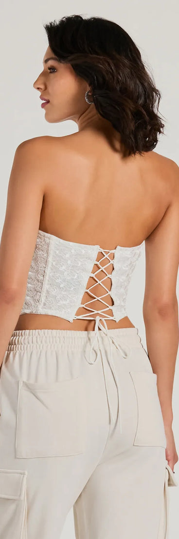 The Show Stopper Strapless Lace Beaded Corset Top in ivory is a sequin top with an all-over sparkle, perfect for creating a glam concert outfit or adding shimmer to a going-out look. 