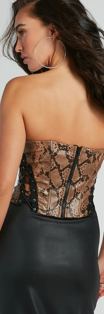 The party-ready Snake Skin Tight Lace-Up Faux Leather Corset Top is a snake print going-out top showcasing a seasonal color and modern silhouette to create outfits for date nights, cocktail parties, or clubwear.
