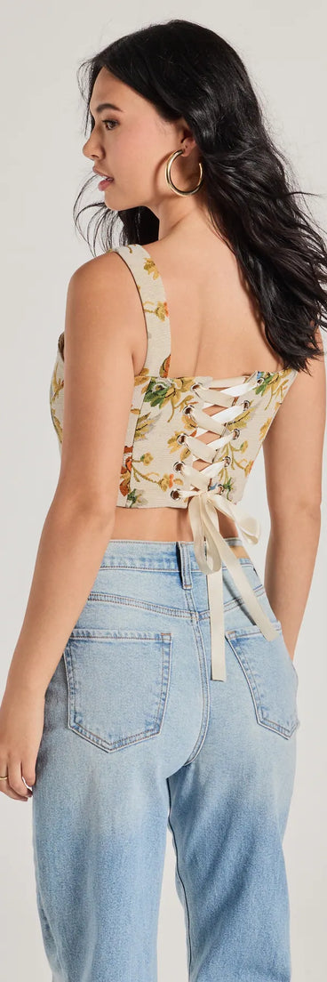 The Garden Fantasy Floral Lace-Up Corset Top in multi-color is a women's workwear piece offering a trendy style and unique accents, perfect for effortlessly creating an outfit-of-the-day look that transitions your office look to going-out ready.