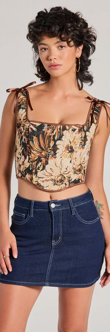 The waist-defining bodice style of the Charming Essence Satin Bow Floral Corset Top in brown is perfect for making a statement with your outfit and provides the structure, molded cups, or lace-up details that capture the corset trend