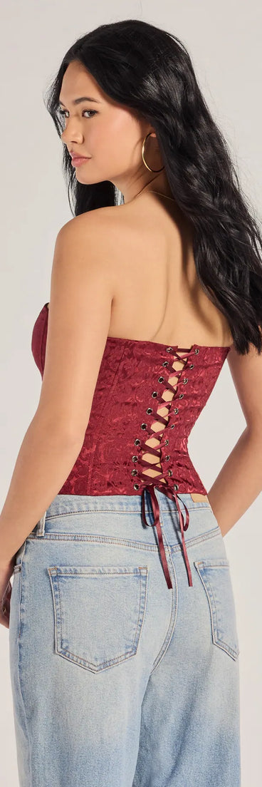 With its midriff cut and trend-forward fit, the Chic Status Brocade Satin Strapless Corset Top is a burgundy crop top made to pair with skirts, denim, or whatever vibe you're feeling this season.
