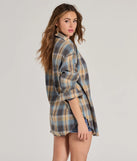 The Casual Staple Plaid Flannel Top is a women's blue long-sleeve top with an elevated style and unique design accents, perfect for layering or transitioning into colder months.