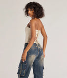 With its midriff cut and trend-forward fit, the Chic Status Brocade Satin Strapless Corset Top is a beige crop top made to pair with skirts, denim, or whatever vibe you're feeling this season.