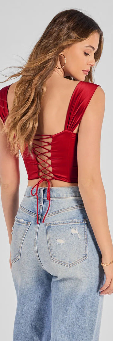 With its midriff cut and trend-forward fit, the Renaissance Spell Lace-Up Satin Corset is a red crop top made to pair with skirts, denim, or whatever vibe you're feeling this season.