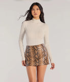 The Winter Slay Turtleneck Long Sleeve Bodysuit in ivory with a modern design and trendy look is part of the latest women's tops collection to elevate your 2025 wardrobe.