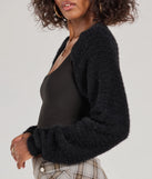 Layer-friendly Cuddly Cozy Eyelash Knit Sweater Bolero is a chic, transitional black long-sleeve top with contemporary sleeves and neckline design, ideal for an elevated cozy style or casual elegance.