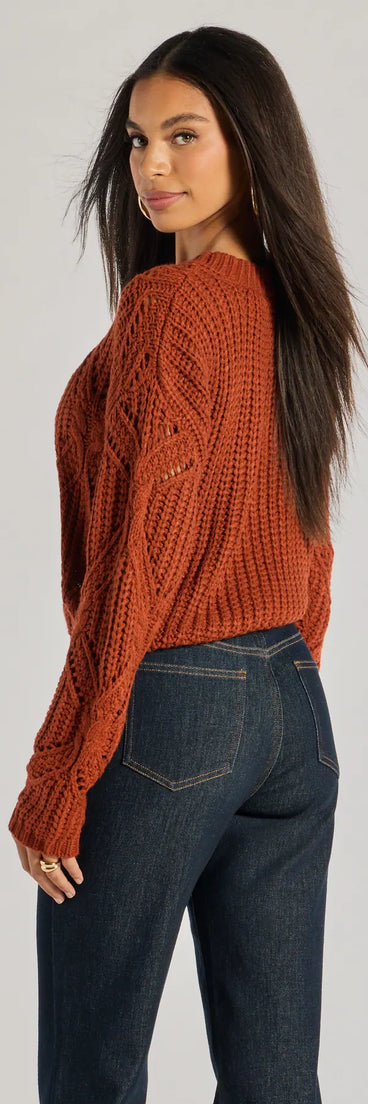 Add a sleek touch to your outfit with this rust long sleeve top—the Cozy Mood Cable Knit Pullover Sweater makes effortless transitions from desk to dinner.