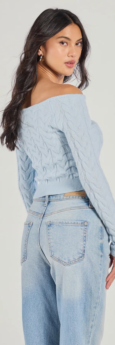 With its midriff cut and trend-forward fit, the Cozy Cutie Off-The-Shoulder Cable Knit Top is a light blue crop top made to pair with skirts, denim, or whatever vibe you're feeling this season.