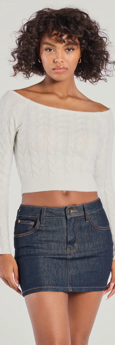 With its midriff cut and trend-forward fit, the Cozy Cutie Off-The-Shoulder Cable Knit Top is a ivory crop top made to pair with skirts, denim, or whatever vibe you're feeling this season.