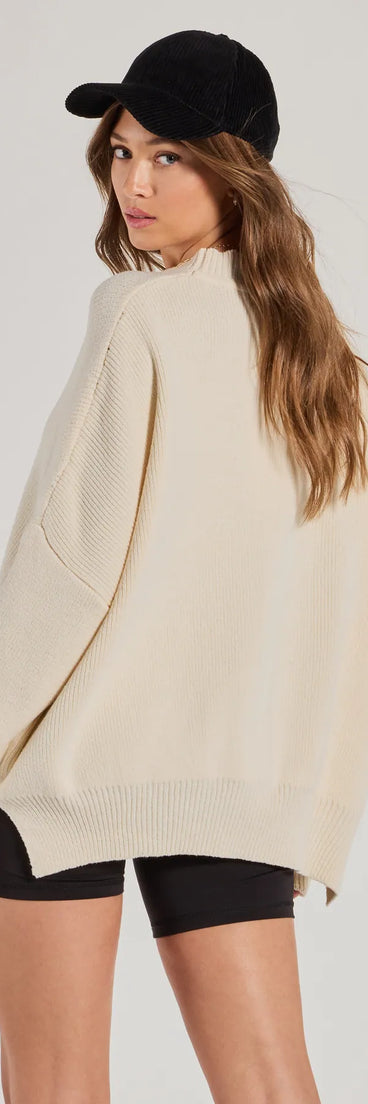 Layer-friendly Cozy Style Ribbed Knit Oversized Sweater is a chic, transitional off-white long-sleeve top with contemporary sleeves and neckline design, ideal for a cozy holiday style or casual elegance.