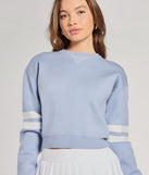 The Varsity Girl Striped Knit Crop Sweater in light blue with a modern design and trendy look is part of the latest women's tops collection to elevate your 2025 wardrobe.