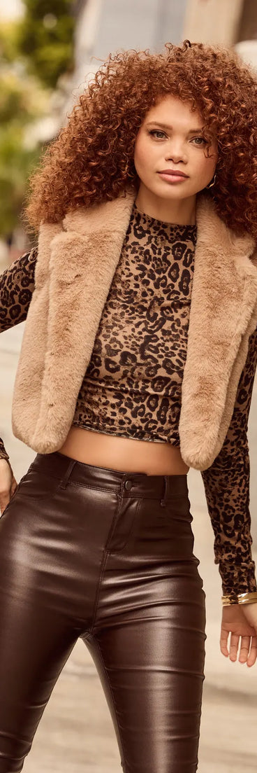 Stay chic this winter with Cozy Glamour Faux Fur Cropped Vest, a heather gray women's coat perfect for layering. Featuring textured fabric and a trendy fit, this lightweight coat for women transitions effortlessly from cozy everyday wear to formal evening events.