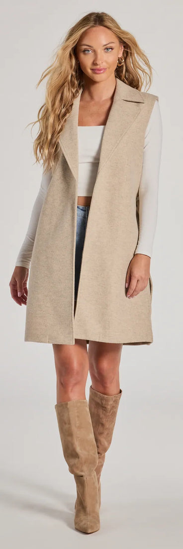 The Autumn Chic Faux Wool Long Belted Vest in oatmeal is a women's workwear essential with an elevated fabric and chic silhouette, ideal for layering and versatile enough to take your look from office chic to going-out ready!