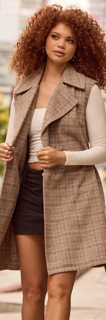 Stay chic this winter with Plaid Pursuit Faux Wool Long Belted Vest, a taupe women's coat perfect for layering. Featuring textured fabric and a trendy fit, this lightweight coat for women transitions effortlessly from cozy everyday wear to formal evening events.