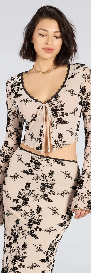 Serve effortless style and scroll-stopping energy in the Flirt Alert Flocked Floral Mesh Tie-Front Top, part of a ivory matching clothing set that does the work for you with bold, polished vibes from top to bottom.
