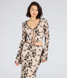 From bold to effortless, the Flirt Alert Flocked Floral Mesh Tie-Front Top lets you define your vibe with ivory tops that speak your style.