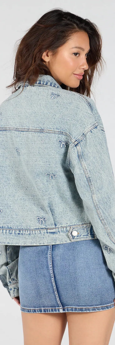 Layer on laid-back style with the Iconic Cutie Bow Trucker Denim Jacket in light blue, a jean jacket perfect for casual looks with a cool-girl twist.